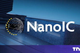 Technicians in protective cleanroom suits inspecting a 300mm silicon wafer at the Imec research center in Leuven, symbolizing the launch of the NanoIC pilot line.