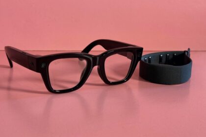 A close-up of a person wearing sleek Meta smart glasses while subtly gesturing with a neural-equipped smartwatch on their wrist.