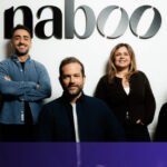 A sleek modern office in New York City where a professional uses an AI procurement platform to manage international corporate events.