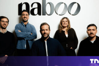 A sleek modern office in New York City where a professional uses an AI procurement platform to manage international corporate events.