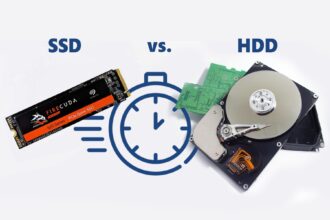 A close-up of a high-speed NVMe SSD next to a blurred gaming monitor showing the Grand Theft Auto V loading screen, illustrating the struggle of game storage.