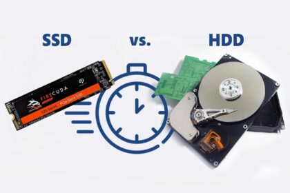 A close-up of a high-speed NVMe SSD next to a blurred gaming monitor showing the Grand Theft Auto V loading screen, illustrating the struggle of game storage.