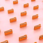 An external NVMe SSD drive sits beside a sleek laptop displaying a terminal window during a Linux distribution installation process.