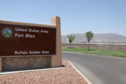 A close-up of a high-resolution smartphone screen displaying distorted, colorful digital static and corrupted text fragments against a dark background.