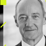 A high-tech automated factory floor featuring robotic arms and glowing blue Siemens logos