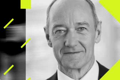 A high-tech automated factory floor featuring robotic arms and glowing blue Siemens logos