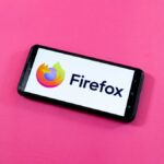 A close-up of a desktop screen showing the Firefox browser settings menu with a toggle switch being clicked to disable AI features.