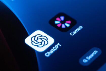 A close-up of a courtroom gavel resting on a digital tablet displaying the OpenAI Sora logo and the word Cameo