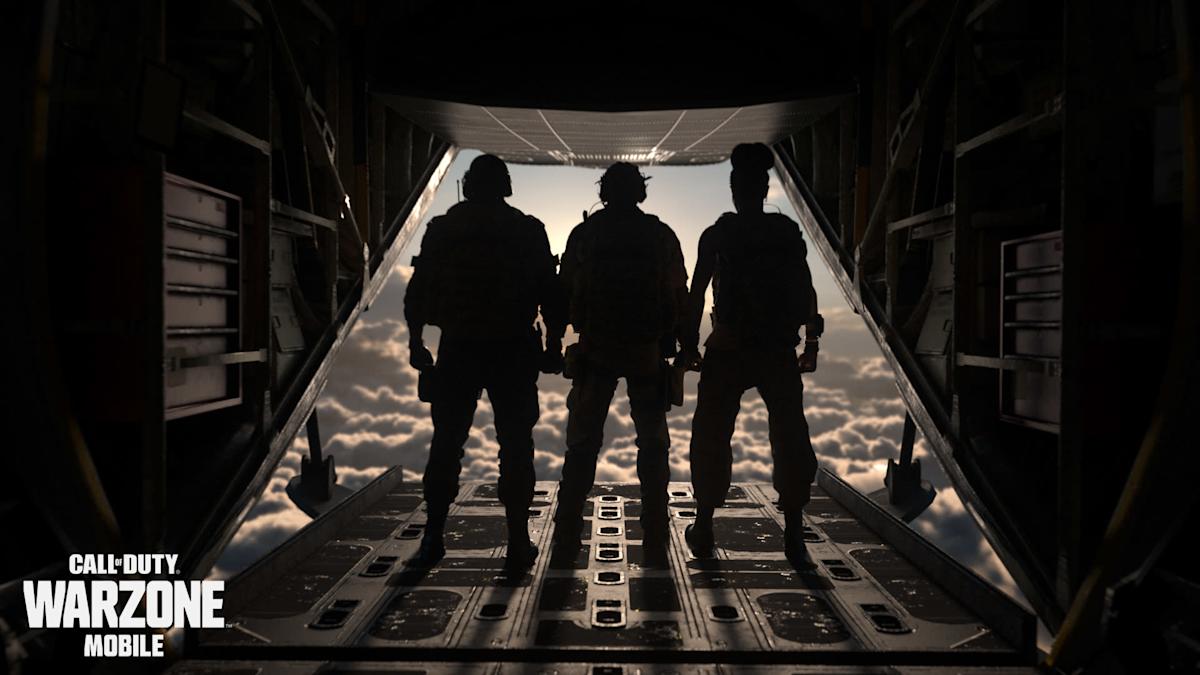 A high-end smartphone lying on a desk displaying the Call of Duty: Warzone Mobile loading screen next to a gaming headset.