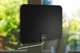 A modern Mohu Gateway Plus indoor TV antenna mounted near a window in a contemporary living room setting.
