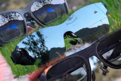A person wearing sleek Xreal 1s smart glasses while relaxing on a plane, showcasing the future of portable spatial computing.