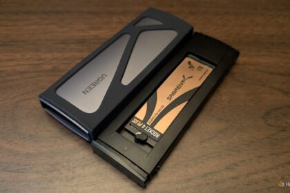 A tangled collection of various USB-C cables and high-end smartphones resting on a modern workstation, highlighting the complexity of universal charging standards.